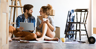 Couple sitting down looking at each other