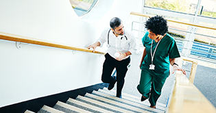 Two doctors walking up stairs